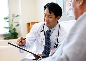 Smiling male doctor discussing over medical record with senior man in hospital
Tokyo, Japan