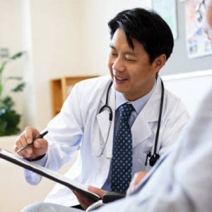 Smiling male doctor discussing over medical record with senior man in hospital
Tokyo, Japan